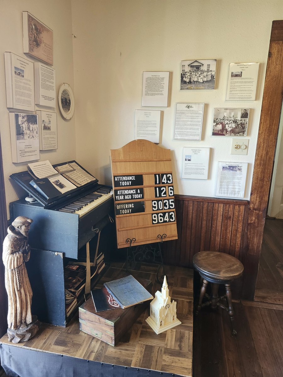 A church corner with an old church sign and a portable pump organ