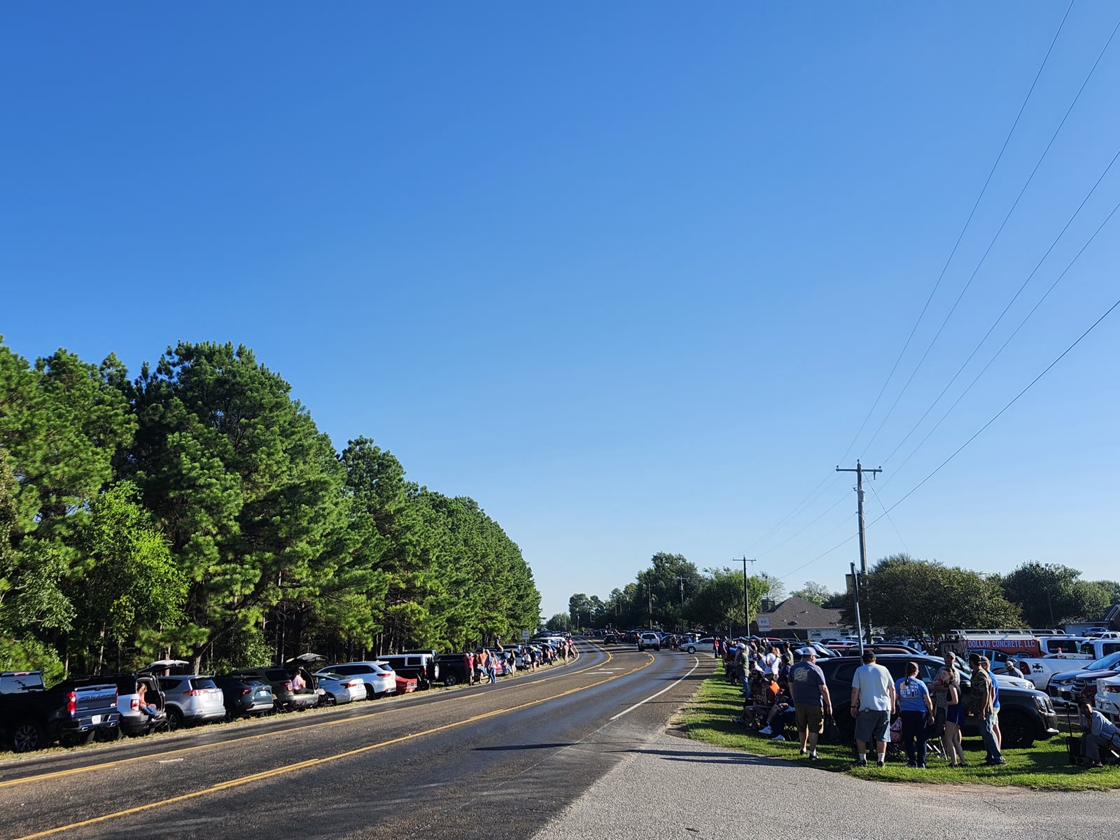 Families with lawn chairs line the road early before the Pow Wow parade