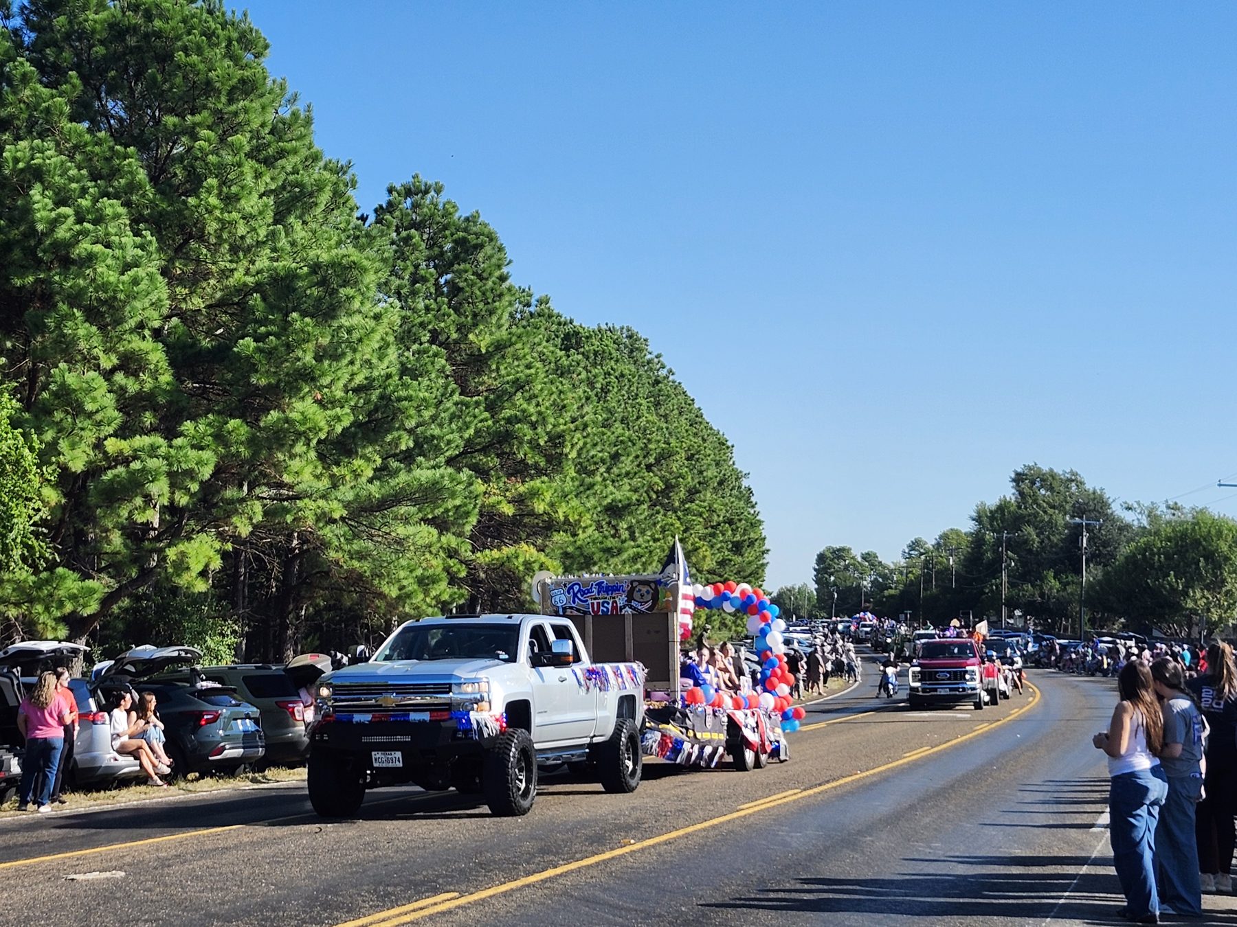 A Road Trippin’ USA parade float decorated with red, white and blue balloons