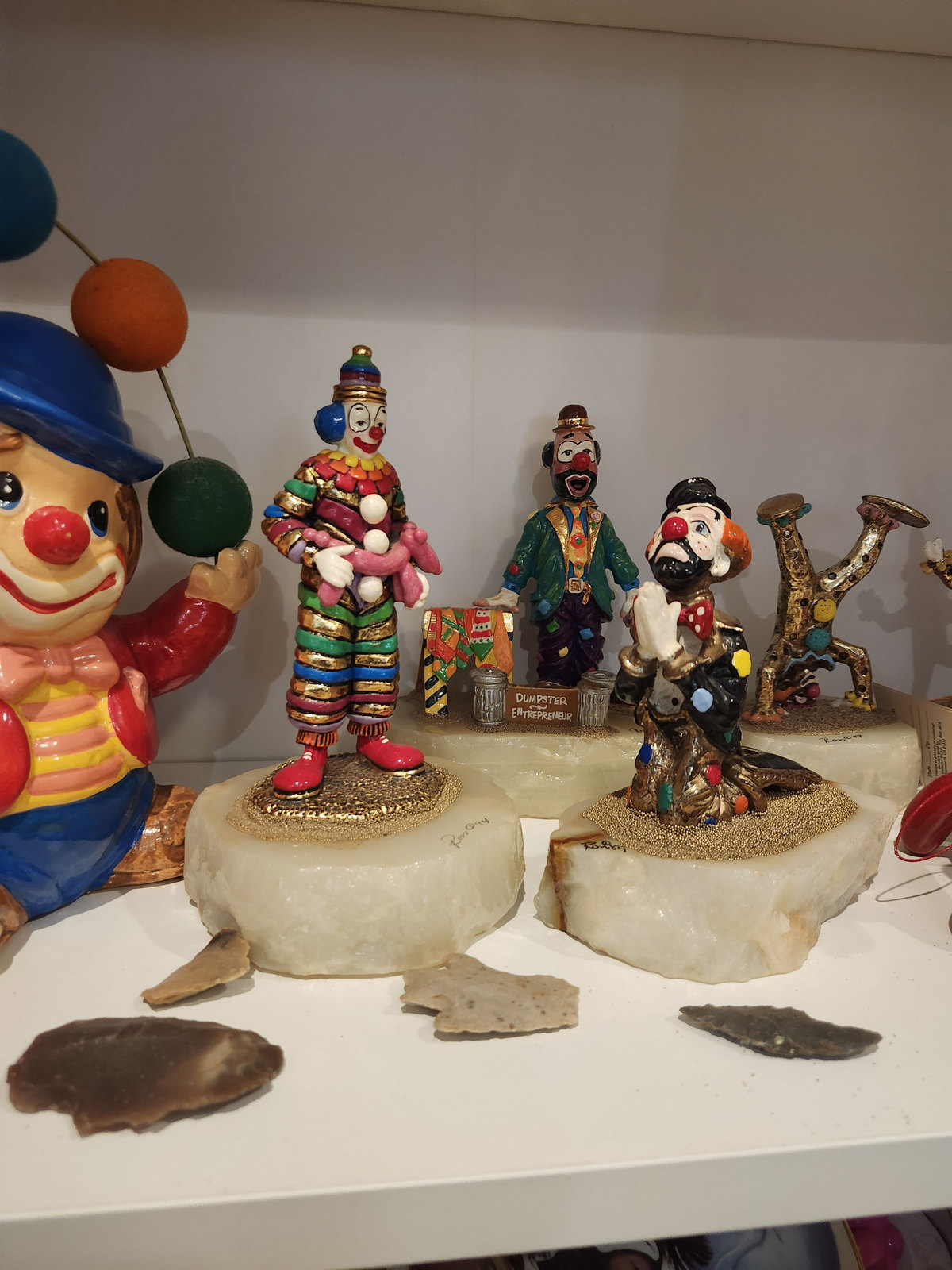 Clown sculptures from Kornpop’s collection on a shelf