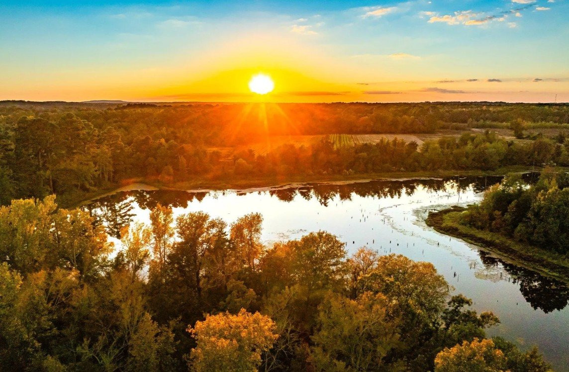 Sunset over Lake Palestine and the wooded shoreline