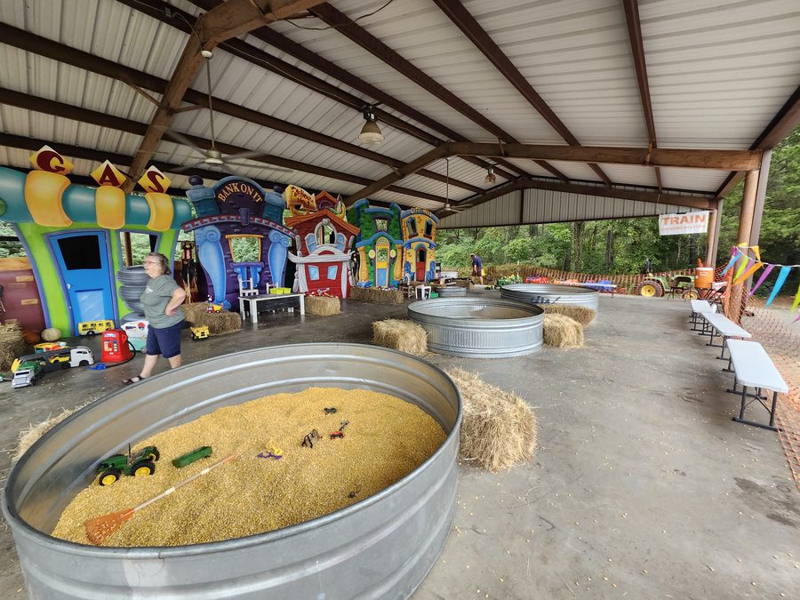 Colorful play houses and corn pits filled with toy tractors keep young visitors busy in the new Pumpkin Place Village